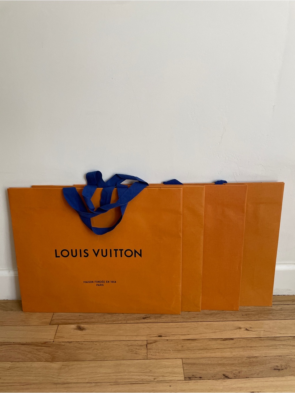 Set of four Louis Vuitton Orange Tote Shopping Bags with Blue Handles and boxes